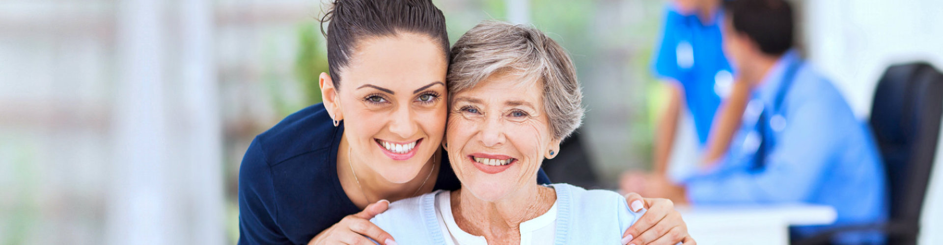 senior woman and a caregiver smiling